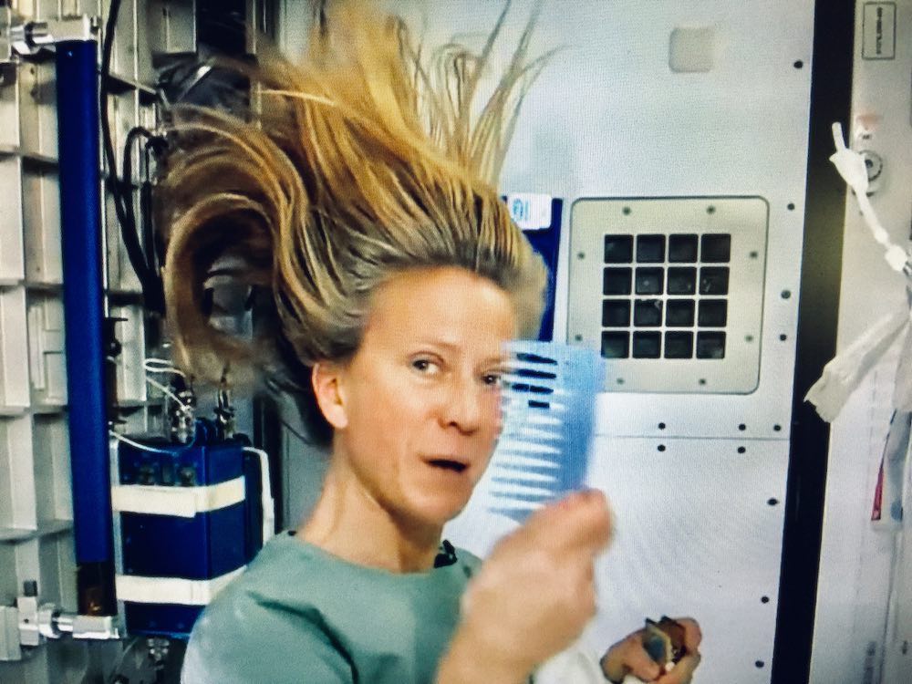 Astronaut Karen Nyberg, combing hair on the ISS.