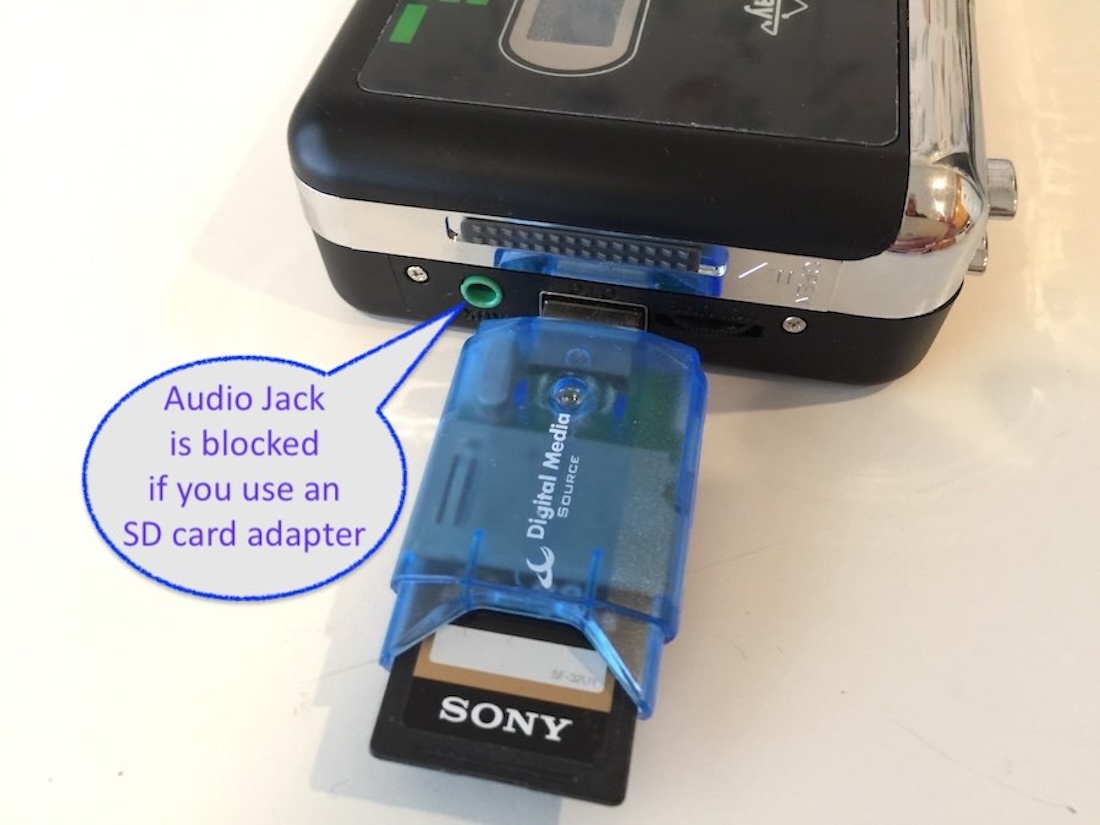 An SD Card adapter blocks the AUX audio jack.