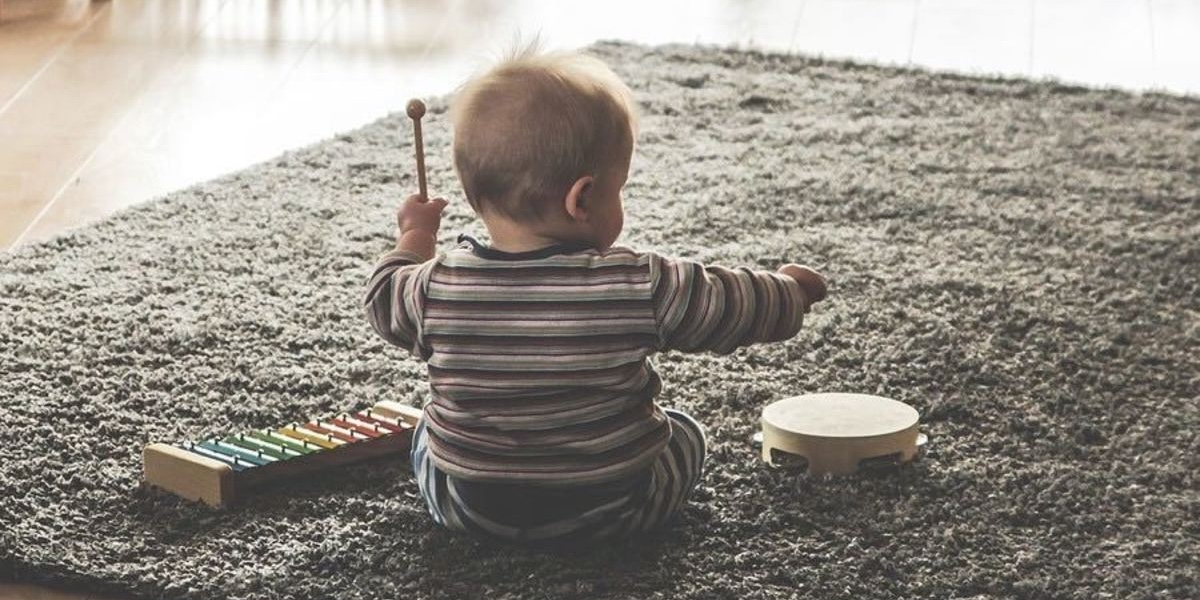 Deaf child playing with sound producing toys