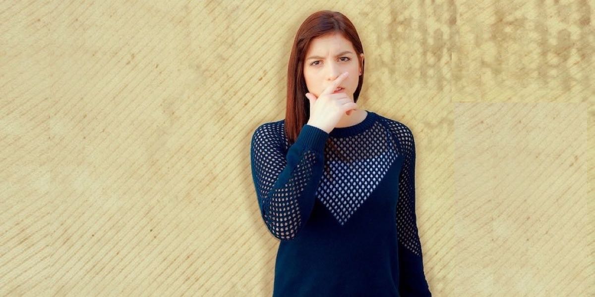 Woman covering her mouth