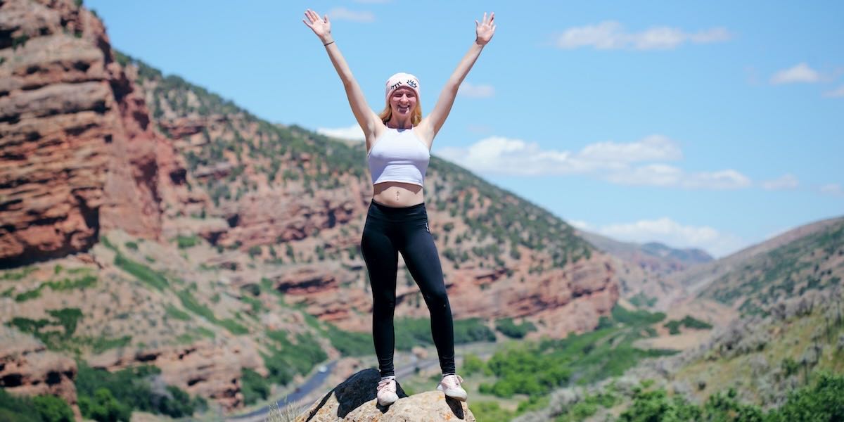Girl looking satisfied climbing mountain