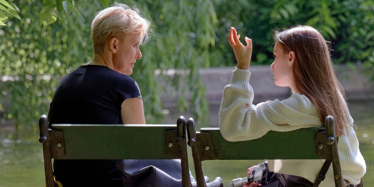 Girls chatting on a park bench