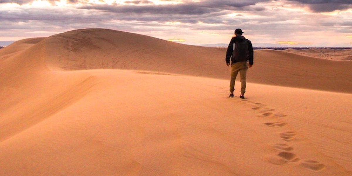Man walking alone in the desert