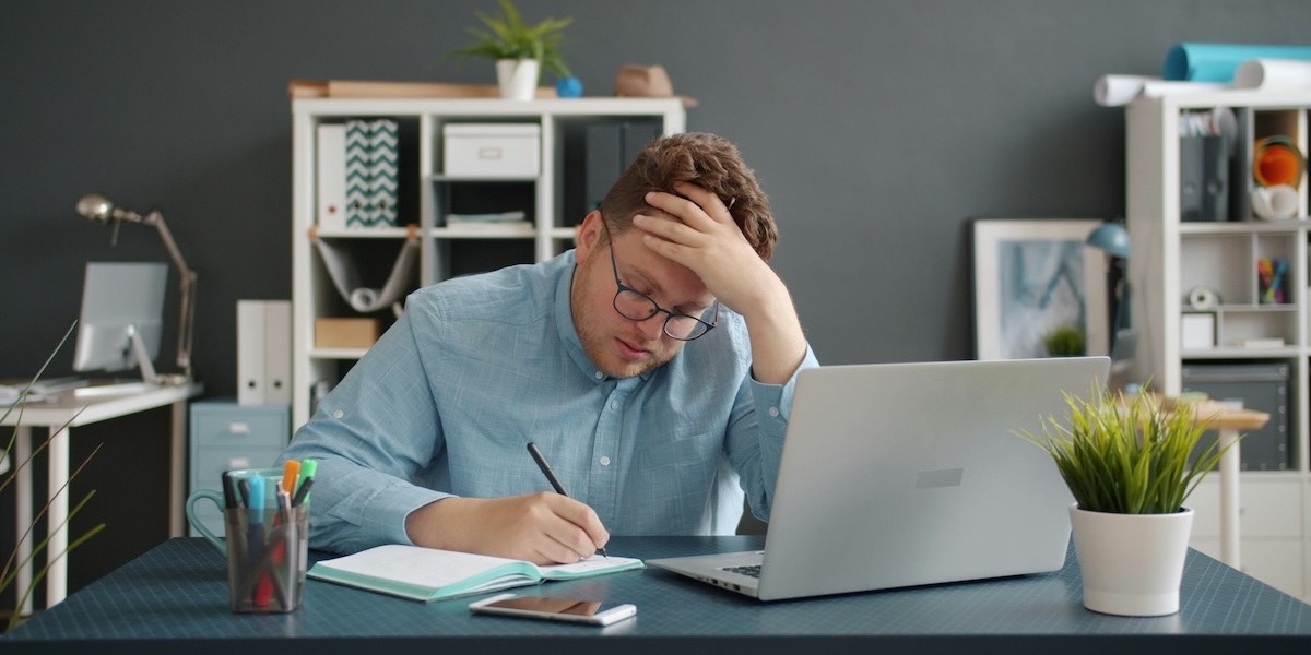 Man writing a letter on desk