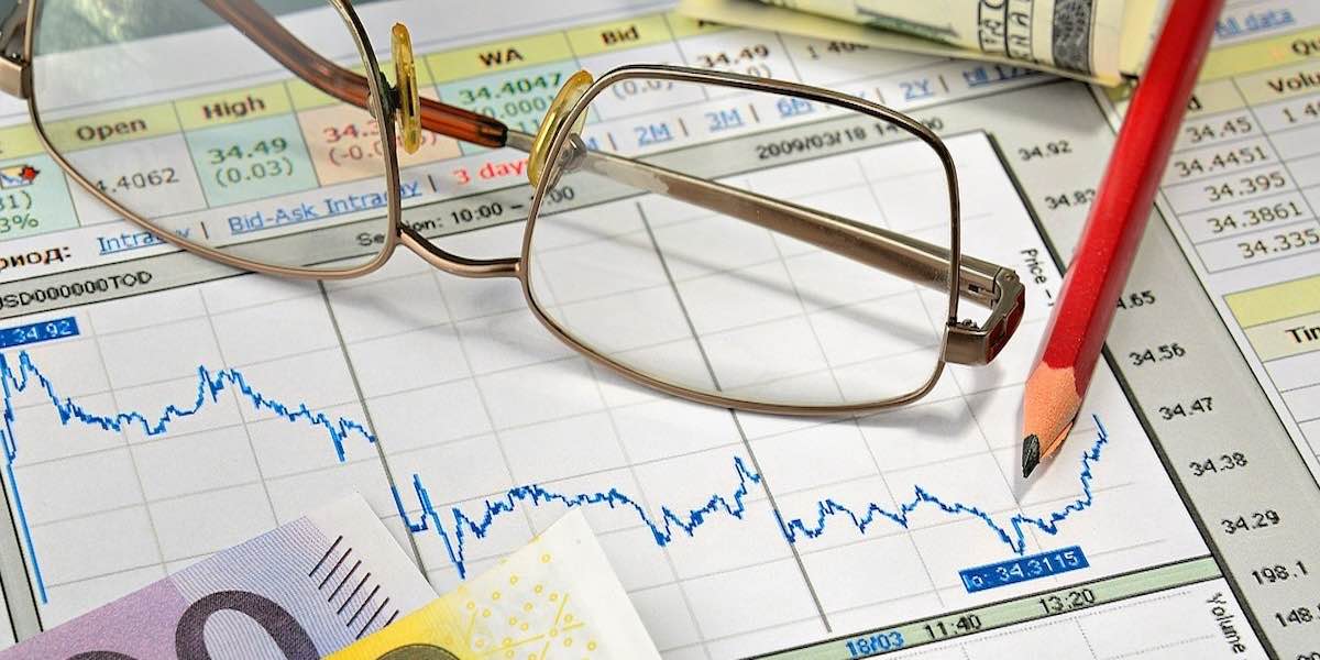 Eye glasses laying on a stock chart