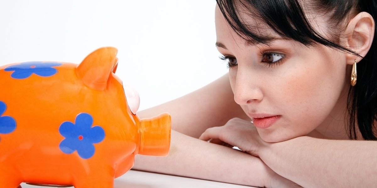Girl watching her piggy bank