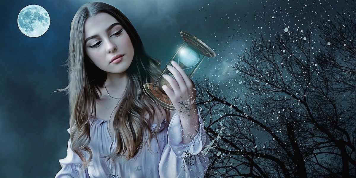 Woman holding a sand timer.