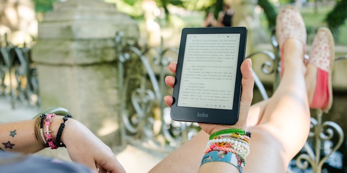 A woman reading from a tablet/ipad.